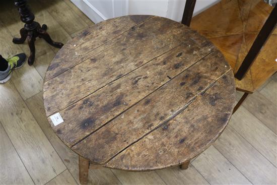 An early 19th century pine circular topped two tier cricket table, H.69cm